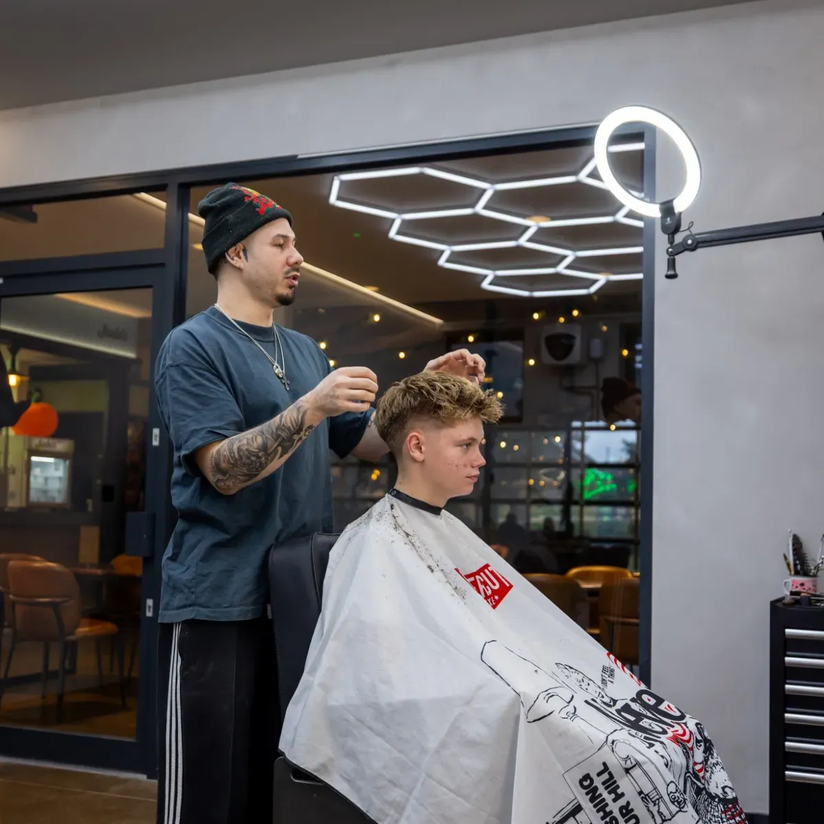 Kristian styling a client's textured crop by the studio window
