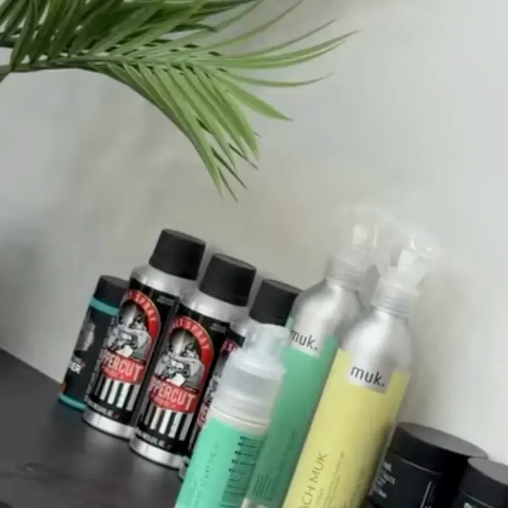 Styling products on the shelf beneath a palm leaf
